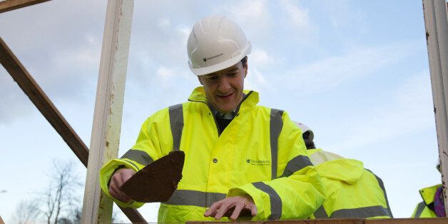 Chancellor of the Exchequer George Osborne lays bricks during a visit to a housing development in South Ockendon in Essex.