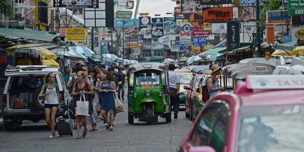 TO GO WITH Thailand-China-unrest-tourism-economy,FOCUS by Preeti JHATourists walk along Khao San road, popular with many foreign visitors, in Bangkok on August 21, 2015. Busloads of visitors from China flocked to Bangkok's glittering Grand Palace on August 21 but, days after a bomb at another of the city's popular attractions killed five Chinese tourists, Thailand's biggest spending holidaymakers are rattled. AFP PHOTO / Christophe ARCHAMBAULT (Photo credit should read CHRISTOPHE AR