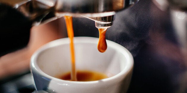 Fresh espresso shot pouring out of machine.