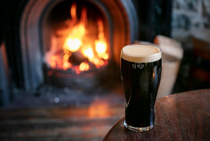 A pint of stout by a roaring fire.