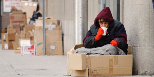 Homeless man drinking coffee