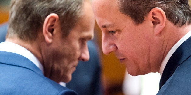 European Council President Donald Tusk, left, speaks with British Prime Minister David Cameron during a round table meeting at an EU summit in Brussels on Friday, June 26, 2015. EU leaders, in a second day of meetings, will discuss migration, the Greek bailout and European defense. (AP Photo/Geert Vanden Wijngaert)