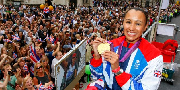 Britain's heptathlon Olympic gold medallist Jessica Ennis poses for a picture as her float passes the Royal Courts of Justice during a parade celebrating Britain's athletes who competed in the London 2012 Olympic and Paralympic Games in central London on September 10, 2012. Britain was bidding a fond farewell om September 10 to a golden summer of Olympic and Paralympic sport with a victory parade by athletes through London ending up at Buckingham Palace.