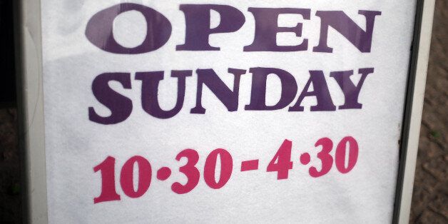 File photo dated 08/07/15 of a sign on the High street in Staines-upon-Thames, Surrey, telling customers of their Sunday opening times, as Government plans to loosen Sunday trading laws in England and Wales are facing defeat in the Commons after the SNP indicated it will oppose them.