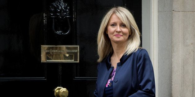 Esther McVey poses for pictures outside 10 Downing Street in London, on October 7, 2013.