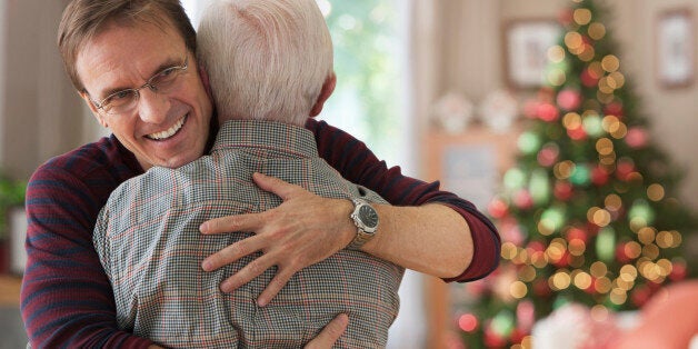 Smiling son hugging his dad at Christmas