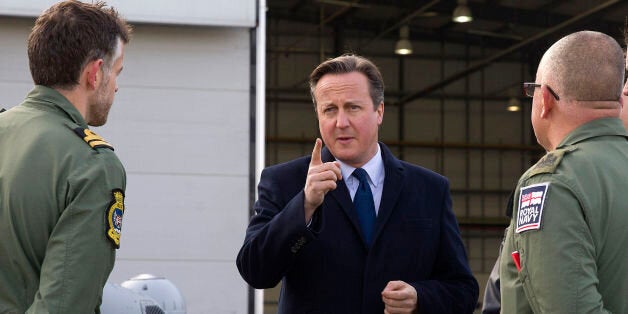 British Prime Minister David Cameron (centre) talks to Royal Navy personnel during his visit to Royal Air Force station RAF Northolt, in west London ahead of his government's Strategic Defence and Security Review (SDSR).