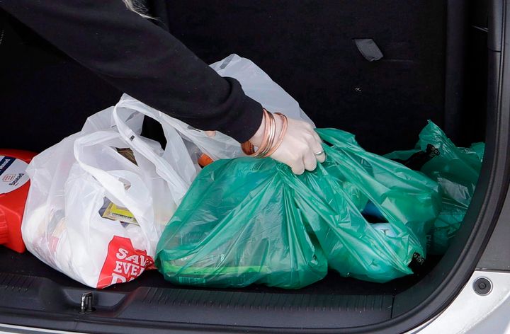 A shopper in New Zealand is seen here putting plastic bags filled with groceries in the trunk of her car. A proposed ban on single-use plastics could make these bags much harder to find in Canada.