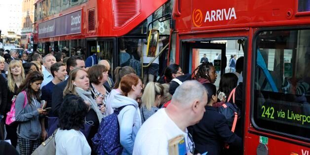 People queue for buses outside Liverpool Street Station, London, as commuters face travel misery trying to get to work because of a strike which has brought London Underground to a standstill.