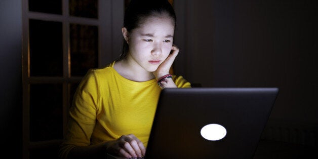 Serious teenager online late at night