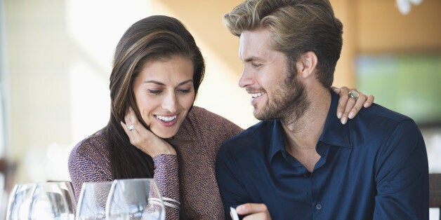 Man with engagement ring proposing his girlfriend in a restaurant