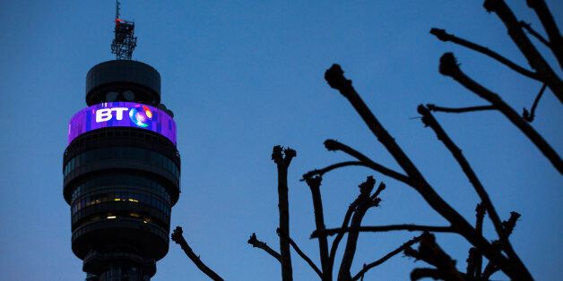 An illuminated BT logo sits above communications equipment on the BT Tower, operated by BT Group Plc, at dusk in London, U.K., on Monday, Dec. 15, 2014. BT started exclusive talks to acquire Deutsche Telekom AG and Orange SA's British wireless venture EE for 12.5 billion pounds ($19.6 billion), moving ahead with a deal that's set to spur more mergers in the U.K. telecommunications market. Photographer: Jason Alden/Bloomberg via Getty Images