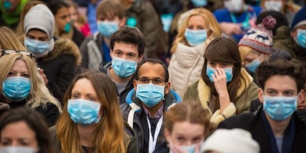 Junior doctors and their supporters stage sit-down protest outside Downing Street, in Westminster, London, during a "masked march" protest over pay and conditions, the third time they have taken to the streets in protest at the Government's proposals, which it says aims to improve care over weekends.