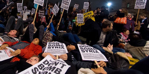 Protesters participate in a 'Die In' protest in Parliament Square