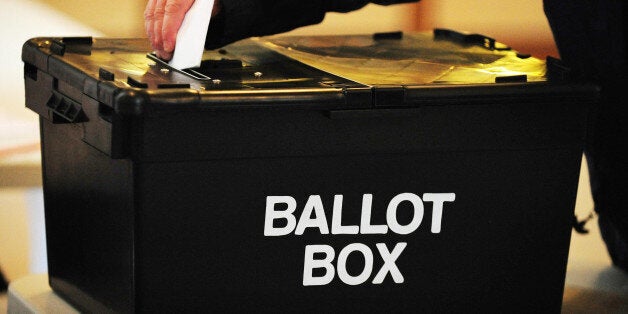 File photo dated 06/05/10 of a voter placing a ballot paper in a ballot box. Citizens from most European Union countries living in the UK will be barred from voting in the referendum on whether to sever ties with Brussels promised by David Cameron.