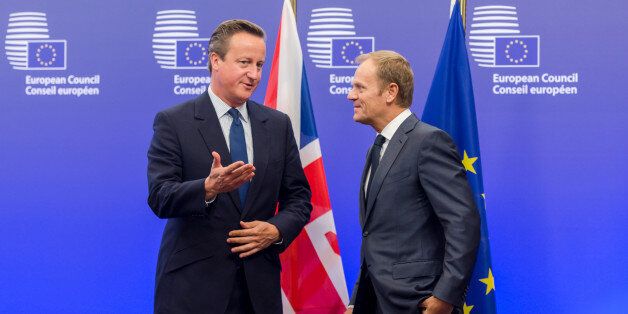 European Council President Donald Tusk, right, welcomes British Prime Minister David Cameron upon his arrival at the EU Council building in Brussels on Thursday, Sept. 24, 2015. (AP Photo/Geert Vanden Wijngaert)