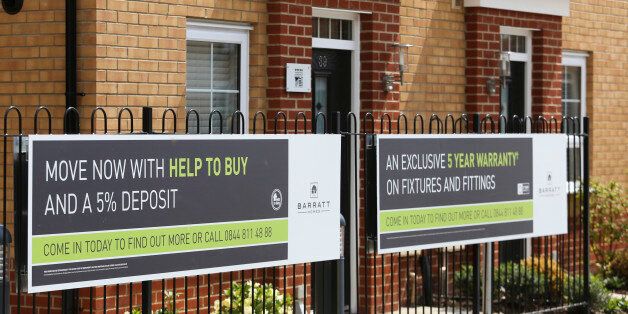 A sign advertising the Government's Help to Buy scheme stands outside new homes