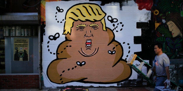 A man passes by a Anti-Donald Trump mural painted on a building in Lower Manhattan on August 28, 2015 in New York City