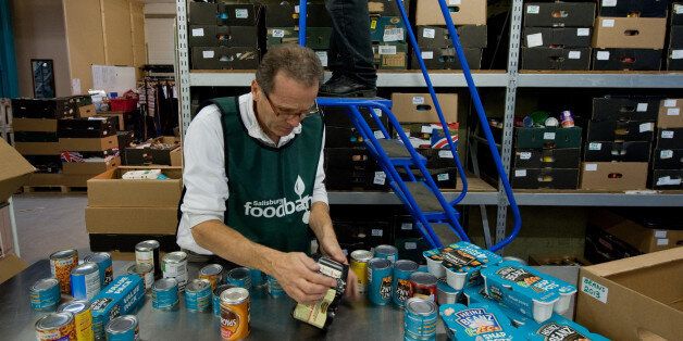 Volunteers sort through donations of food at the headquarters of the Trussell Trust Foodbank Organisation in Salisbury, southern England on November 22, 2012. The Christian charity The Trussell Trust runs 300 food banks in Britain, 100 of which opened in 2012 alone. Although Britain is one of the richest countries in the world, the boom in food banks reflects the growing number of people struggling to balance their income with increases in rent, fuel and food costs. AFP PHOTO / WILL OLIVER (Photo credit should read WILL OLIVER/AFP/Getty Images)