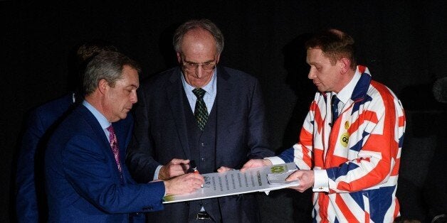 UK Independence Party (UKIP) leader Nigel Farage (L) signs the 'Kettering Accord', a pledge to work cross-party towards a common goal of leaving the EU throughout the upcoming referendum campaign during the launch of the 'Grassroots Out', a new cross-party group that will campaign for the UK to leave the European Union, in the Kettering Conference Centre in Kettering, north of London, on January 23, 2016. An in-or-out referendum on Britain's membership of the bloc will be held by the end of 2017, with British Prime Minister David Cameron hoping to strike a deal on renegotiating Britain's ties, before campaigning to stay in the union. AFP PHOTO / LEON NEAL / AFP / LEON NEAL (Photo credit should read LEON NEAL/AFP/Getty Images)