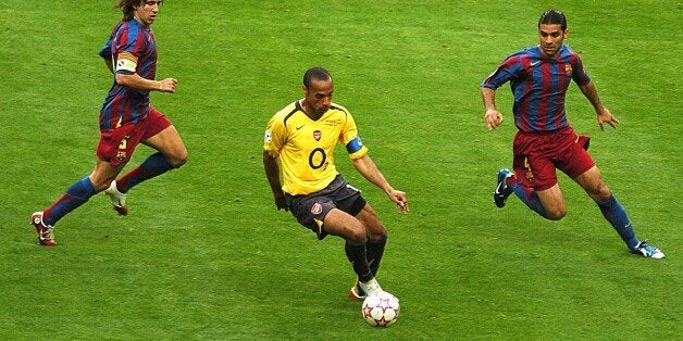 Barcelona's CarlesPuyol (l) and Rafael Marquez (r) close down Arsenal's Thierry Henry