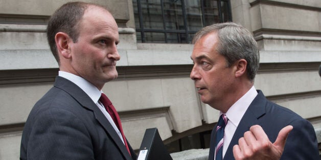 UKIP leader Nigel Farage (right) with Douglas Carswell after a press conference in central London where the Conservative MP defected to his party today.