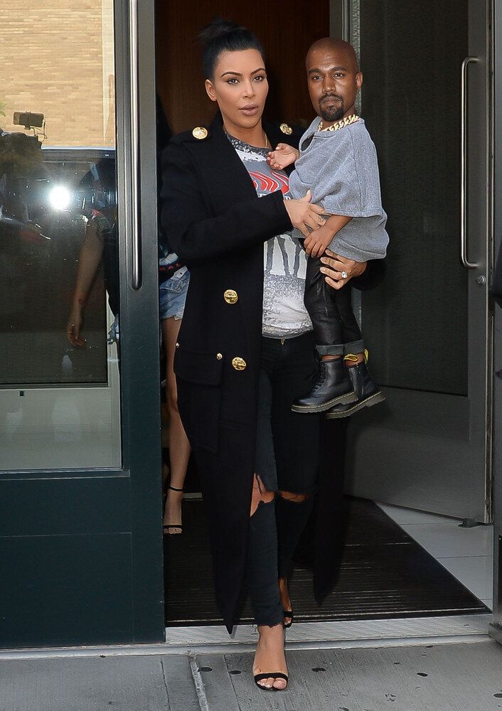 Kim's been left holding baby Kanye again...