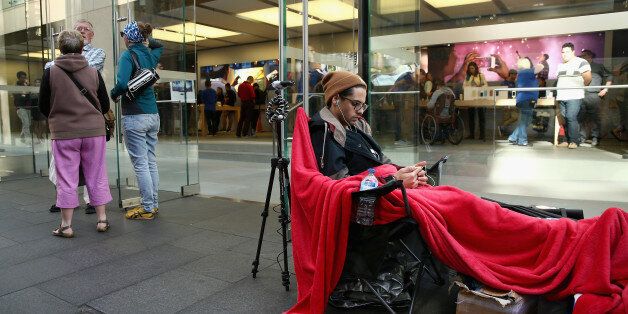 SYDNEY, AUSTRALIA - SEPTEMBER 18: Salvatore Gerace sits at the head of the queue a day before the release of the iPhone 6 outside the Sydney Apple Store on September 18, 2014 in Sydney, Australia. Australian buyers are the first customers able to purchase the new Apple iPhone because of the local time zone, which is several hours ahead of the United States and other parts of the world, going on sale September 19th. (Photo by Cameron Spencer/Getty Images)