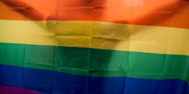 HANOI, VIETNAM - AUGUST 02: A vietnamese man dances as he holds a rainbow flag during the fourth gay pride parade on August 2, 2015 in Hanoi, Vietnam. Hundreds of demonstrators march through the streets of the Vietnamese capital urging an end to discrimination against the lesbian, gay, bisexual and transgender (LGBT) community as homosexuality remains a taboo in Vietnam. (Photo by Borja Sanchez-Trillo/Getty Images)