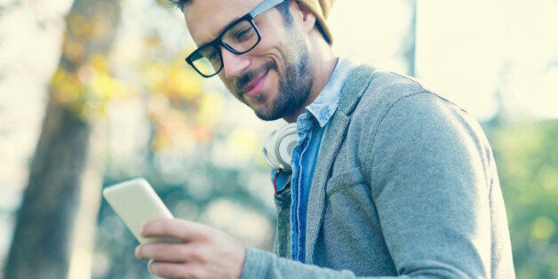 handsome man typing text message