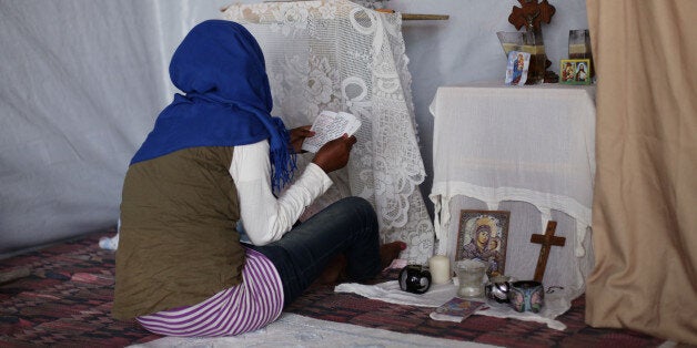 Worshippers attending an Ethiopian Orthodox church erected in the migrant camp known as the new Jungle in Calais, France. PRESS ASSOCIATION Photo. Picture date: Thursday July 30, 2015. Photo credit should read: Yui Mok/PA Wire