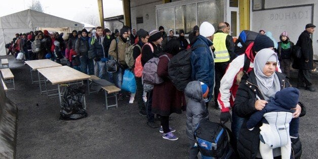 Migrants line up at transit area between Austria and Slovenia at border crossing in Spielfeld, Austria on December 9, 2015. Austria has begun to build a 3,7 km long fence to regulate migrants around the border crossing. AFP PHOTO / JOE KLAMAR / AFP / JOE KLAMAR (Photo credit should read JOE KLAMAR/AFP/Getty Images)