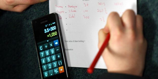 A generic stock picture of a pupil in an economics class using their mobile phone calculator to check their 'share dealings' at the Lawrence Sheriff School. Rugby today.