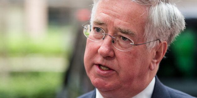 British Secretary of State for Defense Michael Fallon talks with journalists as he arrives for a meeting of EU defense ministers at the European Council building in Brussels on Monday May 18, 2015. (AP Photo/Geert Vanden Wijngaert)