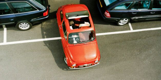 Man parking red car, overhead view