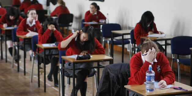 Undated file photo of students sitting an exam. Almost seven in 10 GCSEs could be awarded at least a C grade this year, amid increases in students taking alternative international courses and fewer being entered for exams early, it has been suggested.