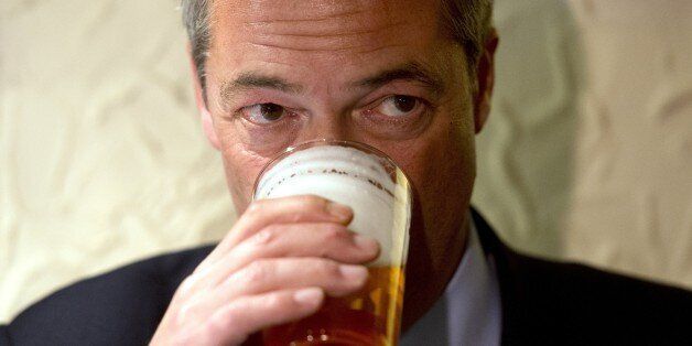 Nigel Farage, leader of the UK Independence Party (UKIP), enjoys a pint of beer in The Gardeners Arms pub after unveiling campaign posters ahead of the Heywood and Middleton by-election in Heywood, Greater Manchester, on October 7, 2014. AFP PHOTO / OLI SCARFF (Photo credit should read OLI SCARFF/AFP/Getty Images)
