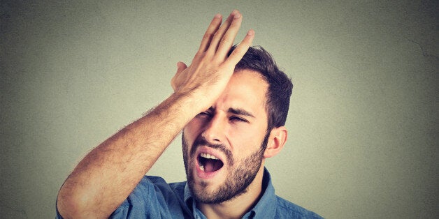 Regrets wrong doing. Closeup portrait silly young man, slapping hand on head having a duh moment isolated on gray background. Negative human emotion facial expression feeling, body language, reaction