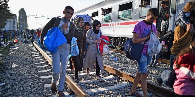 TOVARNIK, CROATIA - SEPTEMBER 18: People move past a train on the tracks as migrants remain at Tovarnik railway station waiting to leave following crossing from Serbia on September 18, 2015 in Tovarnik, Croatia. Officials are saying that they had no choice than to close eight road border crossings yesterday after more than 11,000 people entered the country since Hungary fenced off its border with Serbia earlier this week. (Photo by Jeff J Mitchell/Getty Images)
