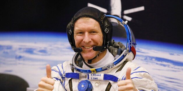 FILE - In this Tuesday, Dec. 15, 2015 file photo, British astronaut Tim Peake, member of the main crew of the expedition to the International Space Station (ISS), gestures prior the launch of Soyuz TMA-19M space ship at the Russian leased Baikonur cosmodrome, Kazakhstan. Anyone can dial a wrong number, but its not often done from outer space. Peake tweeted an apology on Christmas Day from the International Space Station after calling a wrong number. (AP Photo/Dmitry Lovetsky, File)