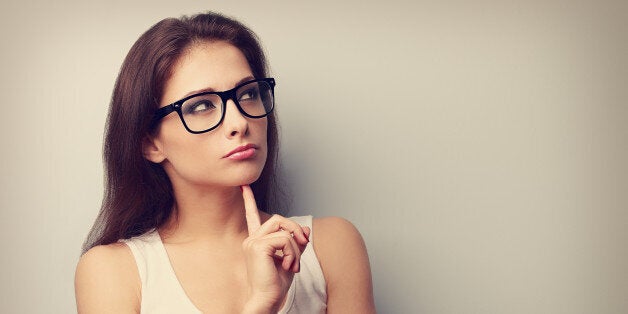 Serious fun thinking young woman looking up on empty copy space. Vintage portrait