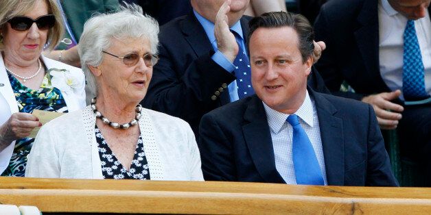 Britain's Prime Minister David Cameron, front right, and his mother Mary arrive to watch Andy Murray of Britain face Novak Djokovic of Serbia in the Men's singles final match at the All England Lawn Tennis Championships in Wimbledon, London, Sunday, July 7, 2013