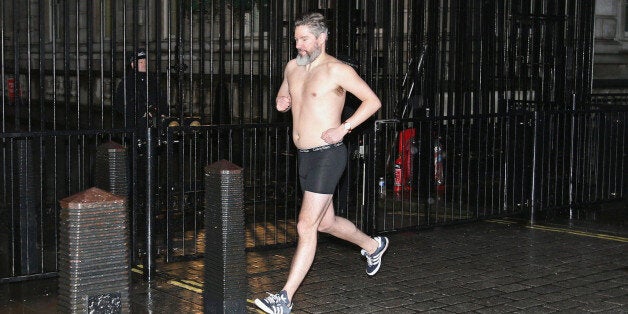 Daily Telegraph political journalist Dan Hodges streaks past Downing Street, London, after losing a bet for underestimating the Ukip's influence during last year's general election.