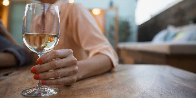 Woman drinking white wine on patio