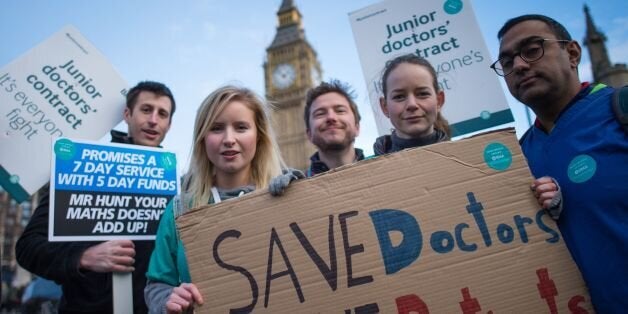 Junior doctors and medical students demonstrate outside the Houses of Parliament in London as part of a nationwide one day strike in a dispute with the government over new contracts.