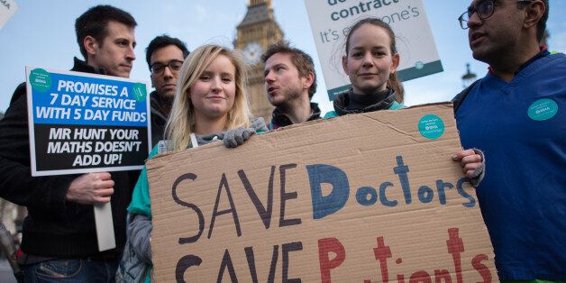 Junior doctors and medical students demonstrate outside the Houses of Parliament in London as part of a nationwide one day strike in a dispute with the government over new contracts.