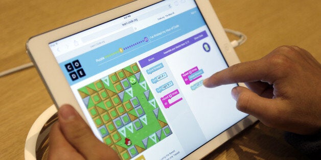 Matthew Triska, 13, learns to build code using an iPad at a youth workshop at the Apple store on Wednesday, Dec. 11, 2013, in Stanford, Calif. Apple stores nationwide were participating in computer science education week Wednesday, part of a joint effort with code.org to teach children the basics of coding. (AP Photo/Marcio Jose Sanchez)