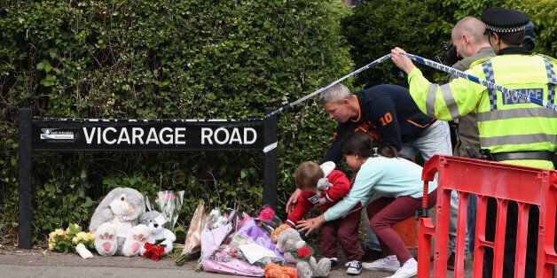 DIDCOT, ENGLAND - MAY 25: Members of the public lay tributes near the home of three people who were found dead at their home, on May 25, 2015 in Didcot, England. Janet Jordon, 48, her six-year-old daughter Derin and Philip Howard, 44, were found dead at their home in Didcot on May 23, 2015. The hunt for Jed Allen, the man suspected of killing the three has entered its second day. (Photo by Dan Kitwood/Getty Images)