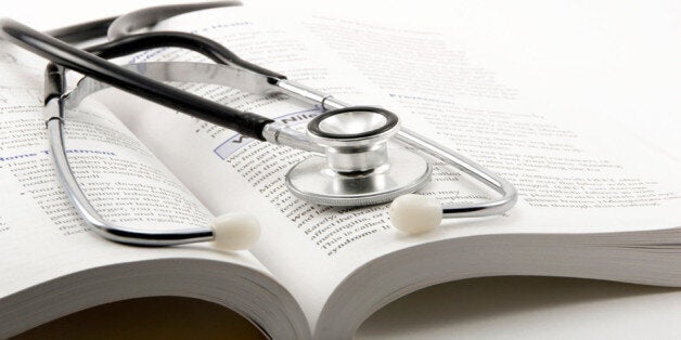 stethoscope on open book on a white background