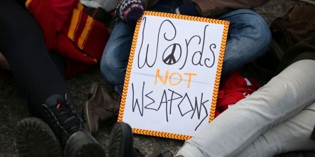 Anti-Trident demonstrators sit in the road at the entrance at the North Gate at HM Naval Base Clyde, Faslane.